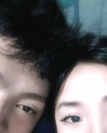 a man and a woman are looking at the camera with their eyes closed