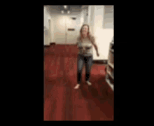 a person is laying on the floor in a hallway with a red carpet .