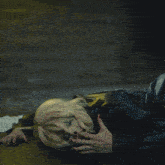 a woman in a black leather jacket is laying on the floor