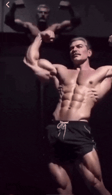 a statue of a man flexing his muscles with a reflection of himself