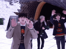a group of people standing in front of a sign that says ticket box