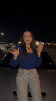 a blurry photo of a woman in a blue top and white pants