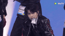 a man in a black leather jacket has a name tag that says ' kingdong ' on it