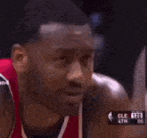 a close up of a basketball player 's face with a scoreboard in the background that says cle 4th