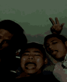 a group of young men are posing for a picture and one of them is making a funny face