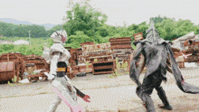 a man in a robot costume is standing next to another man in a black suit
