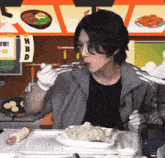 a man eating a meal with a sign that says hbd on it