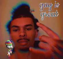 a man taking a picture of himself with the words gay is great below him