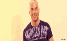 a man in a purple american eagle shirt is smiling .