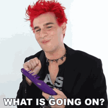 a man with red hair is holding a purple comb with the words what is going on written below him