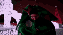 a man in a devil costume is standing in the dark .