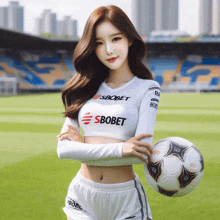a woman holding a soccer ball and wearing a shirt that says sbobet
