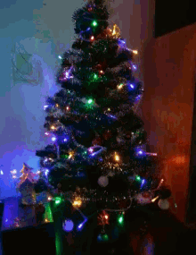 a christmas tree with blue lights and green tinsel