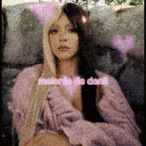 a woman with half blonde and half black hair is wearing a pink sweater with the words melanie de dani written on it