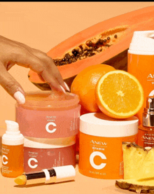 a woman 's hand is reaching for a container of anew vitamin c