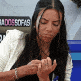a woman is sitting in front of a sign that says ' radossofas '