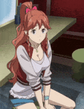 a girl with red hair and a ponytail is sitting at a table
