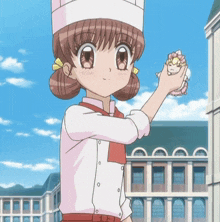a girl in a chef 's hat is holding a stuffed animal