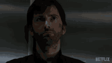 a close up of a man 's face with the word netflix on the bottom