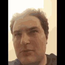 a close up of a man 's face with a serious expression .