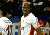 a soccer player wearing a white shirt with the word sixt on the front