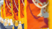 a row of yellow and red flags with tassels