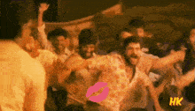 a group of people are dancing in a room with a hk logo on the bottom