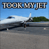 a woman is walking towards a plane with the words took my jet written above her