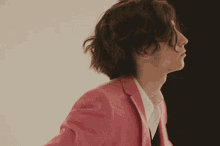 a woman in a pink jacket and white shirt