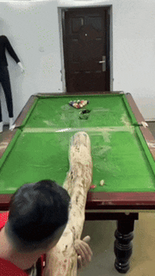 a pool table with a person 's foot on it