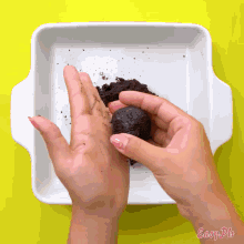 a person is holding a ball of dirt in their hand in front of a white dish that says easy pie on the bottom