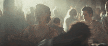 a crowd of people are gathered in a dark room