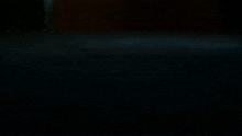 a dark room with a blurred background and a few lights coming out of the corner .