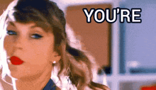 a close up of a woman 's face with the words " you 're " in the background
