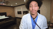 a man in a lab coat with a stethoscope on his neck