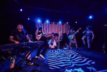 a roland keyboard is on the stage with a band