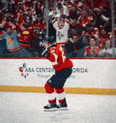 a hockey player in front of a banner that says aba center on it