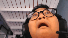 a man wearing glasses and headphones is looking up at the camera