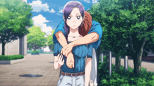 a man is carrying a woman on his shoulders in a park