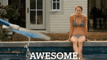 a woman in a bikini is sitting on the edge of a swimming pool with the words awesome written on the bottom