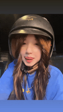 a woman wearing a helmet that says koace