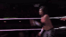two men are wrestling in a ring and one of them is wearing a cowboy hat