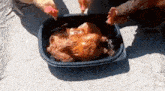 two chickens are eating a roasted chicken in a plastic container