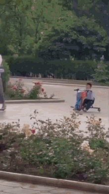 a person is riding a scooter down a street .