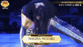 a female wrestler named nagisa nozaki is kneeling down in a ring