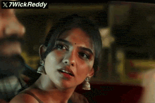 a close up of a woman 's face with the words x7wickreddy written above her