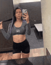 a woman taking a picture of herself in a mirror with a phone that says i love you