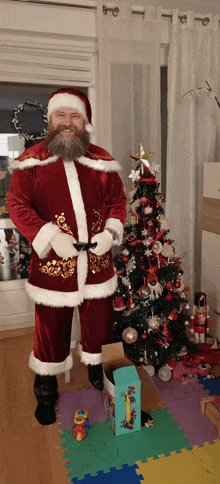 a man dressed as santa claus stands in front of a decorated christmas tree