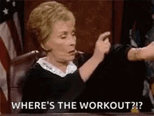 a judge is sitting at a table and pointing at someone while asking where 's the workout ?