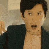 a man wearing a choker and a green jacket is making a funny face .